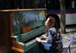 Meagan Wagner plays one of the upright pianos have been placed along Denver's 16th Street Mall. People are invited to sit down and play.  The program by  the Downtown Denver Partnership is called "Your Keys To The City." Lyn Alweis/The Denver post
